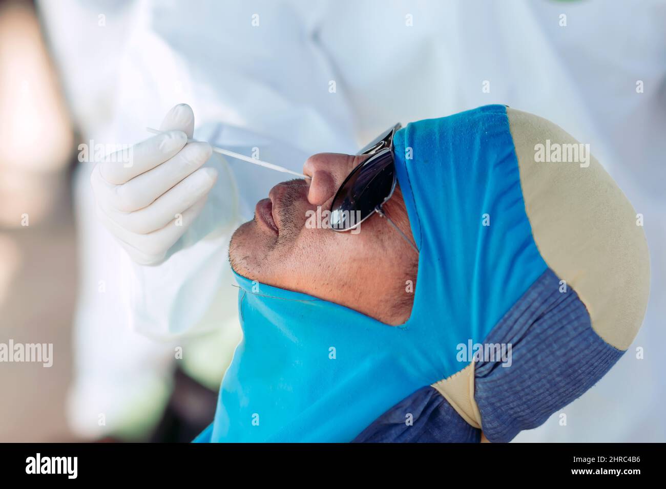 Man having a COVID-19 antigen test done by a medical professional Stock Photo