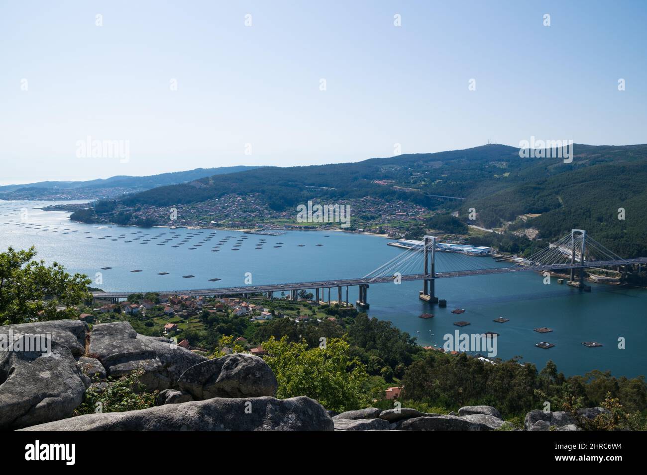 View of mussel rafts and Rande Bridge across Ria de Vigo from Galicia, Spain Stock Photo