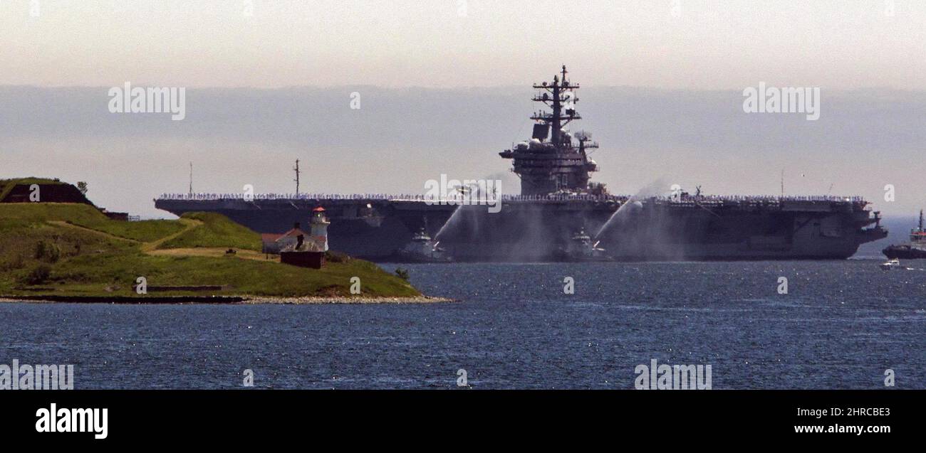 The aircraft carrier USS Dwight D. Eisenhower is to the city