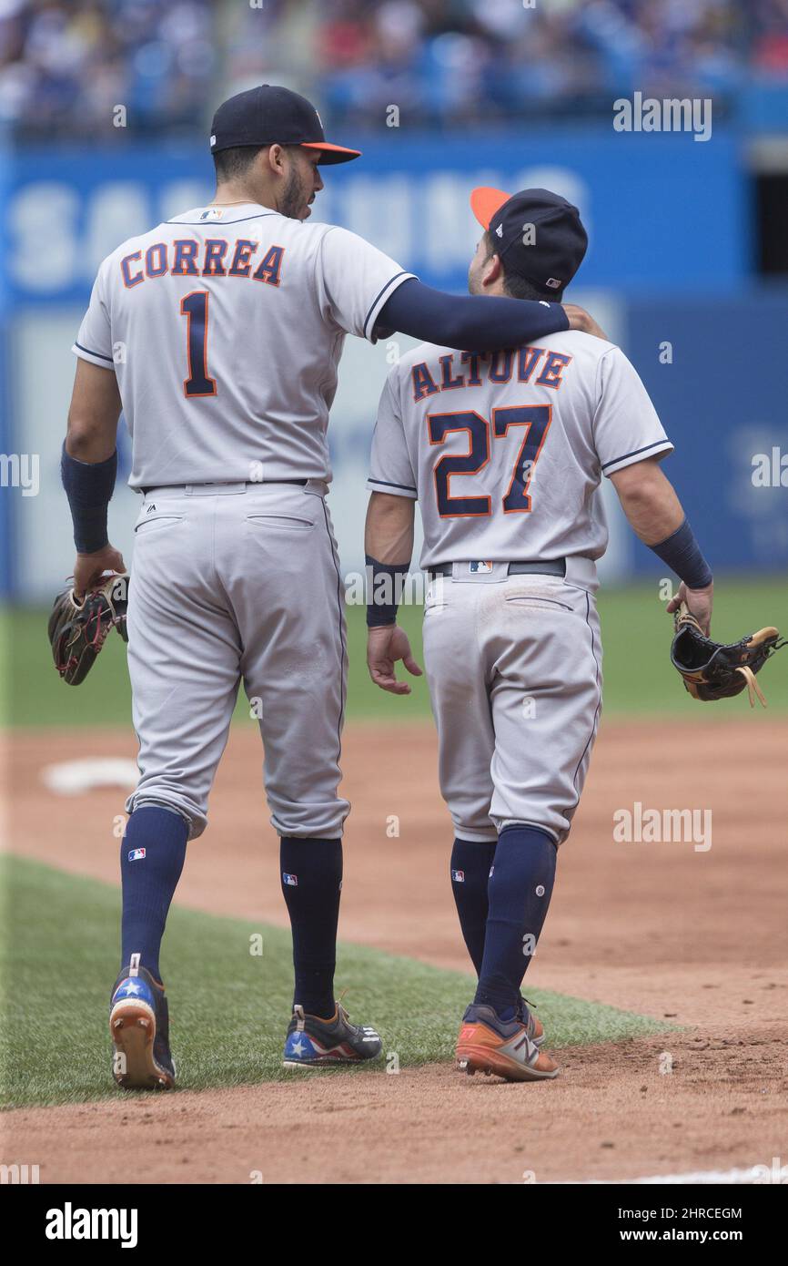 Houston Astros second baseman Jose Altuve (27) and shortstop Carlos Correa  laugh at the end of their 4-3 victory over the Oakland Athletics in a  baseball game, Wednesday, Aug. 31, 2016, in