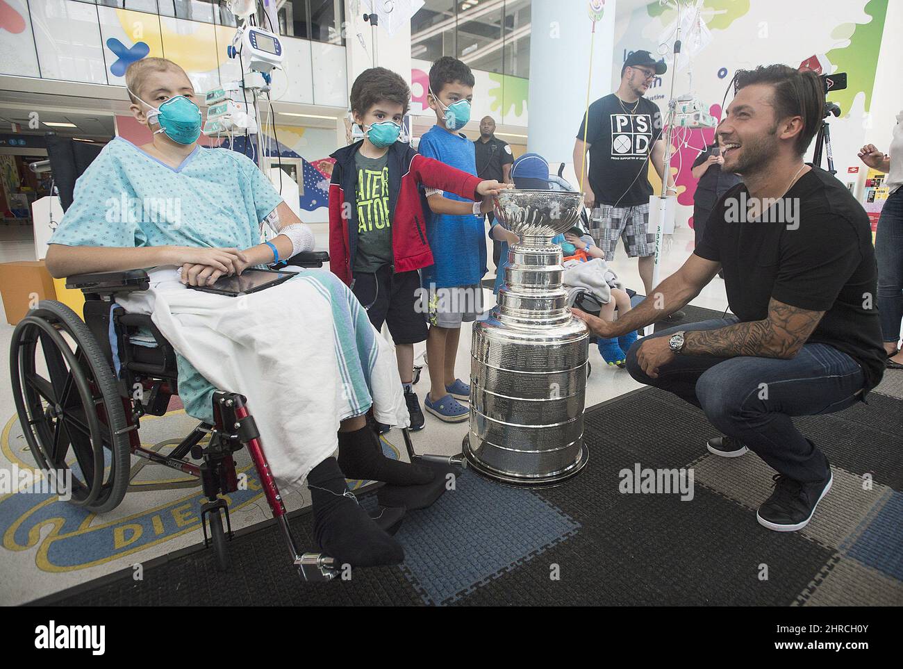 https://c8.alamy.com/comp/2HRCH0Y/pittsburgh-penguins-kris-letang-shows-off-the-stanley-cup-to-children-during-a-visit-to-sainte-justine-hospital-for-sick-children-in-montreal-sunday-july-23-2017-the-canadian-pressgraham-hughes-2HRCH0Y.jpg