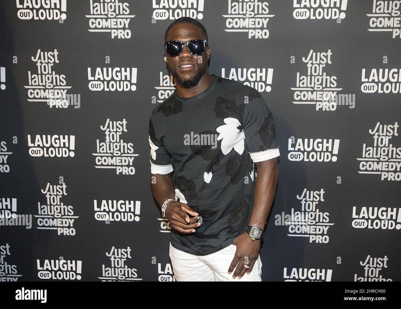 Comedian Kevin Hart poses as he arrives on the red carpet for Eat My