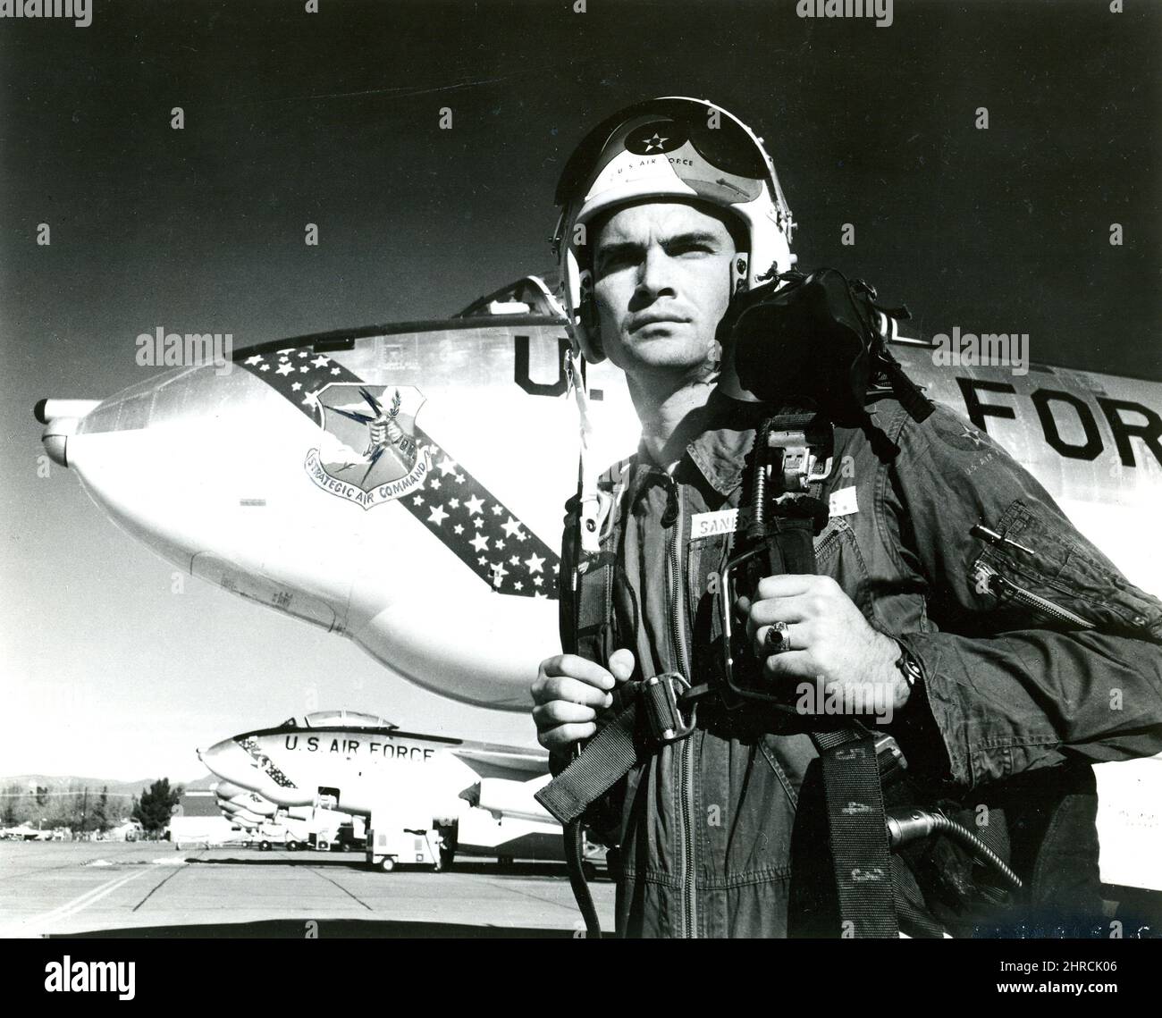 1957 - The crest on this Strategic Air Command B-47 bomber and every SAC plane conveys the mission of its men and weapons. The Command crest of SAC depicts a mailed fist, holding in readiness symbolic lightning bolts of destruction and an olive branch of peace. Standing by the bomber is a typical SAC pilot. Stock Photo