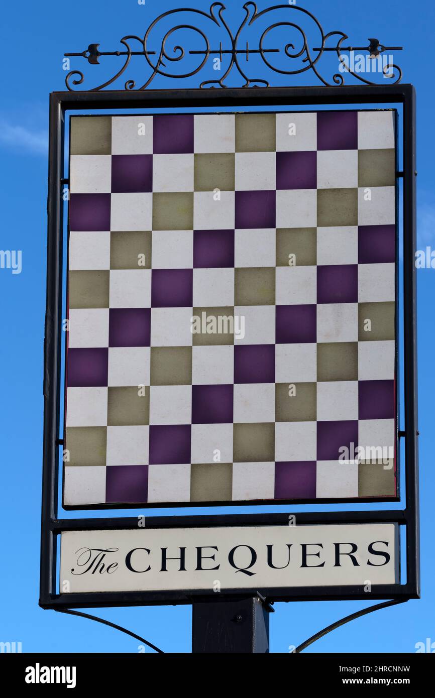 Traditional hanging pub sign at The Chequers public house and restaurant, Reading Road, Eversley Cross, Yateley, Hampshire, England, UK Stock Photo