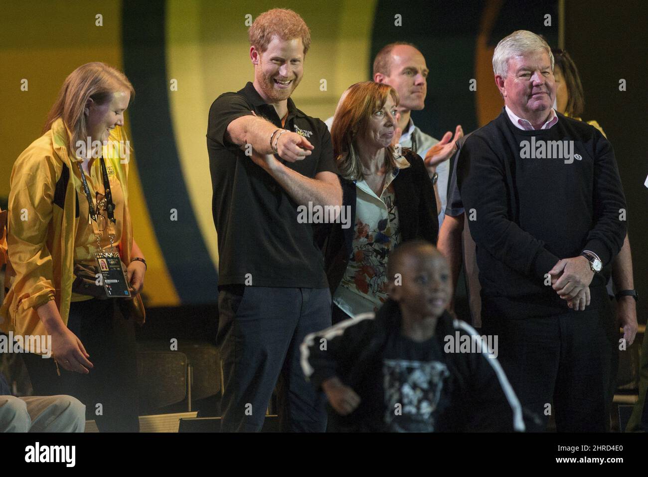 Prince Harry reacts as Ethan Sawyer runs out to congratulate his father