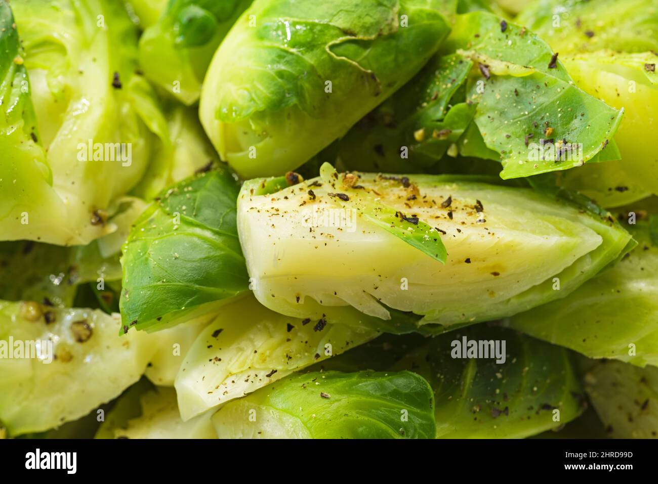 detail of cut and cooked brussels sprouts with herbs and spices Stock Photo