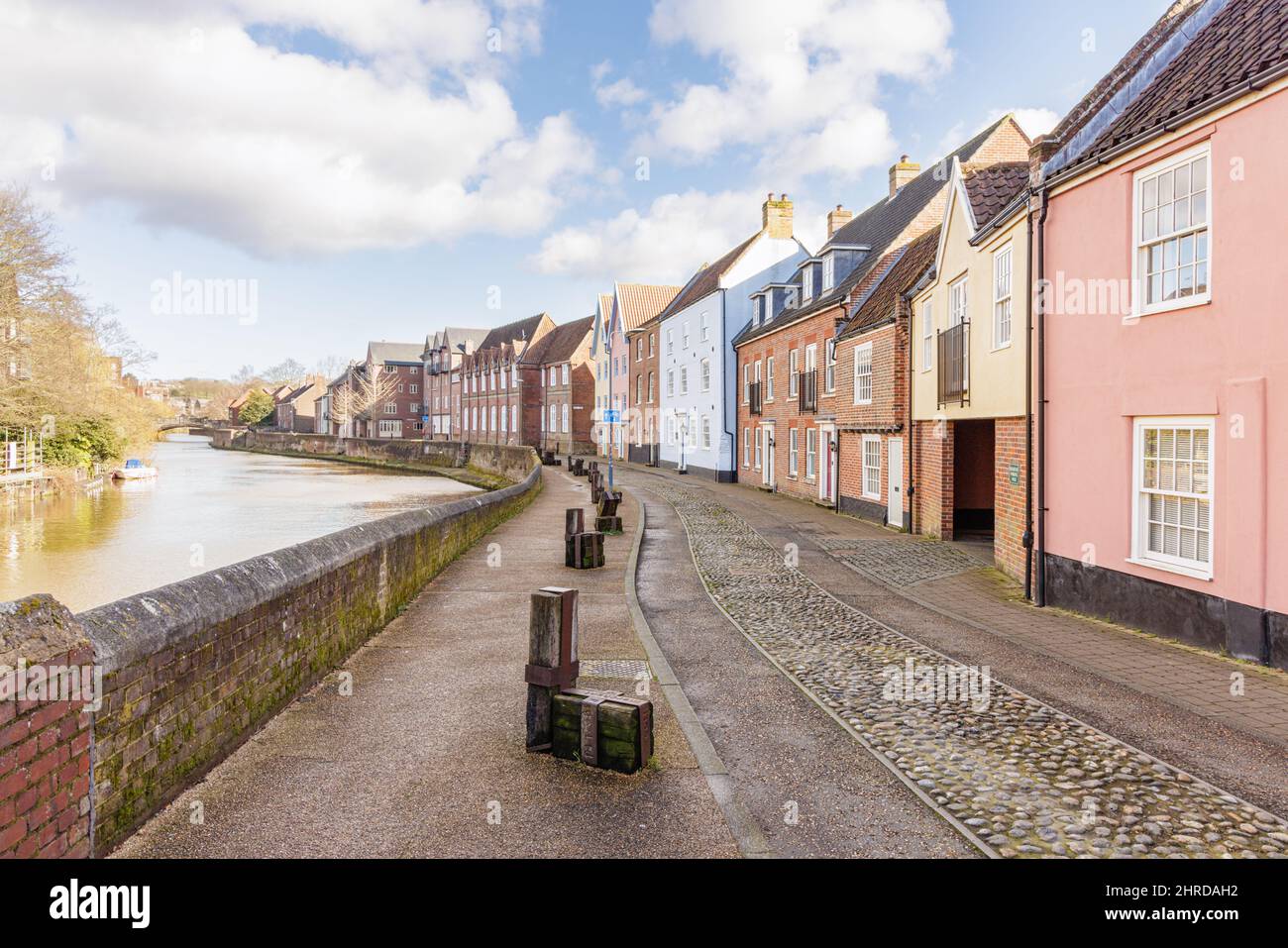 Norwich, Norfolk, UK, February 21st 2022: Quayside, a quiet road lined with houses, runs alongside the River Wensum as it winds through the city. Stock Photo