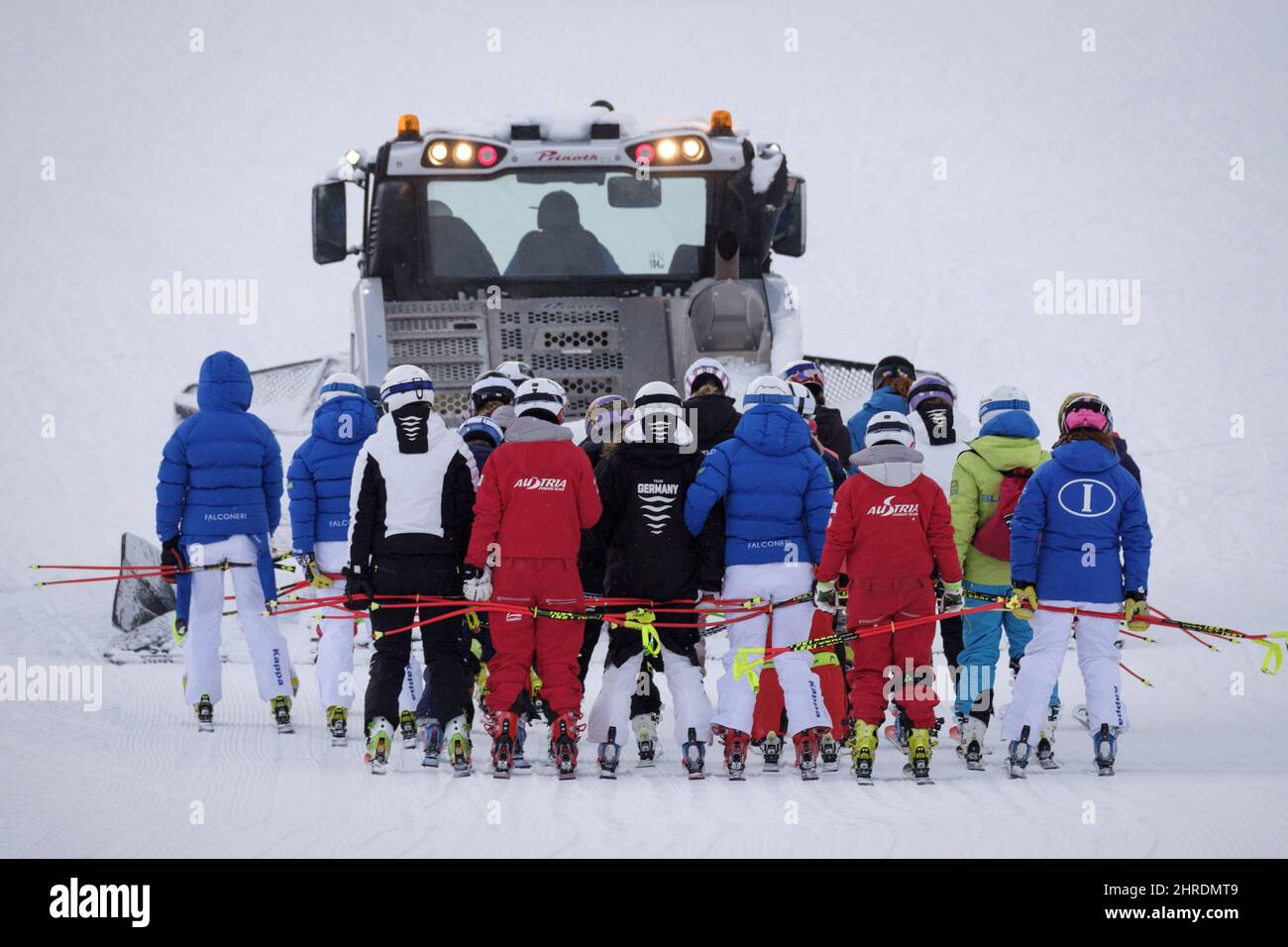 Racers are towed up the hill by a snow cat after a power failure forced