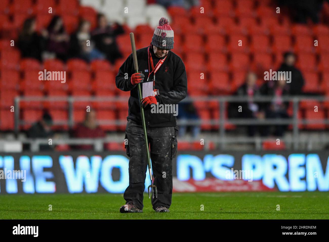 A member of the grounds team makes last minute preparations to the pitch before the game between St Helens and Wakefield Trinity Stock Photo