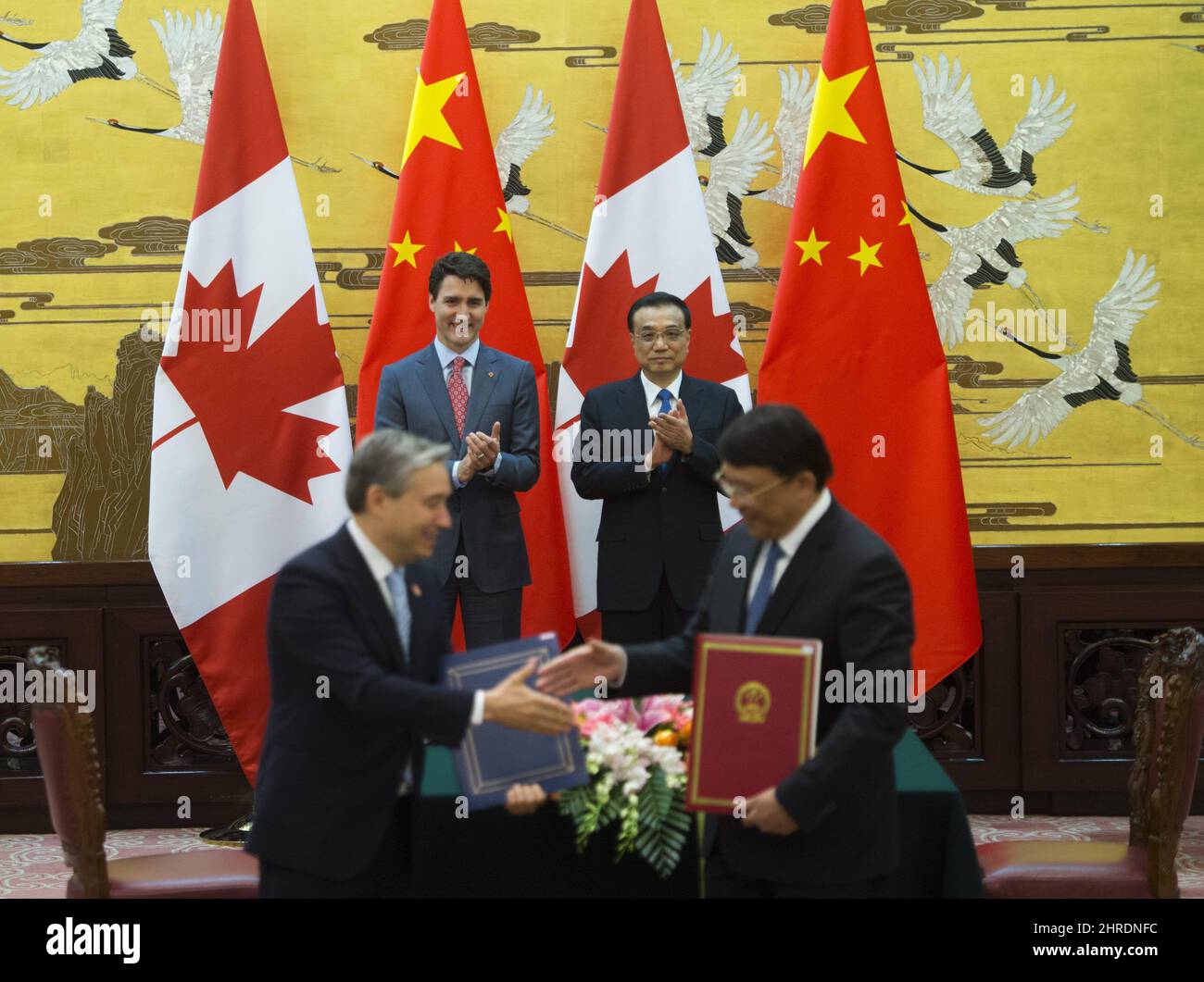 Prime Minister Justin Trudeau Chinese and Premier Li Keqiang look on as International Trade minister, Francois-Phillippe Champagne, left, shakes hands with Chinese counterpart during a signing ceremony at the Great Hall of the People in Beijing, China on Monday, Dec. 4, 2017. THE CANADIAN PRESS/Sean Kilpatrick Stock Photo