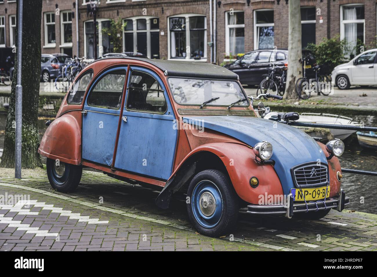 Classic red and blue colored Citroen 2CV car on the street Stock Photo