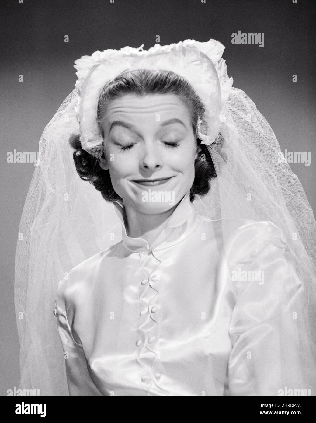1950s PORTRAIT WOMAN BRIDE SMILING EYES CLOSED MAKING A FUNNY FACE WEARING HEADPIECE WITH NET VEIL AND SATIN WEDDING DRESS - b10402 DEB001 HARS CELEBRATION FEMALES MARRIED STUDIO SHOT EVENT HEALTHINESS COPY 1950s PORTRAIT WOMAN BRIDE SMILING EYES CLOSED MAKING A FUNNY FACE WEARING HEADPIECE WITH NET VEIL AND SATIN WEDDING DRESS - b10402 DEB001 HARS CELEBRATION FEMALES MARRIED STUDIO SHOT EVENT HEALTHINESS COPY