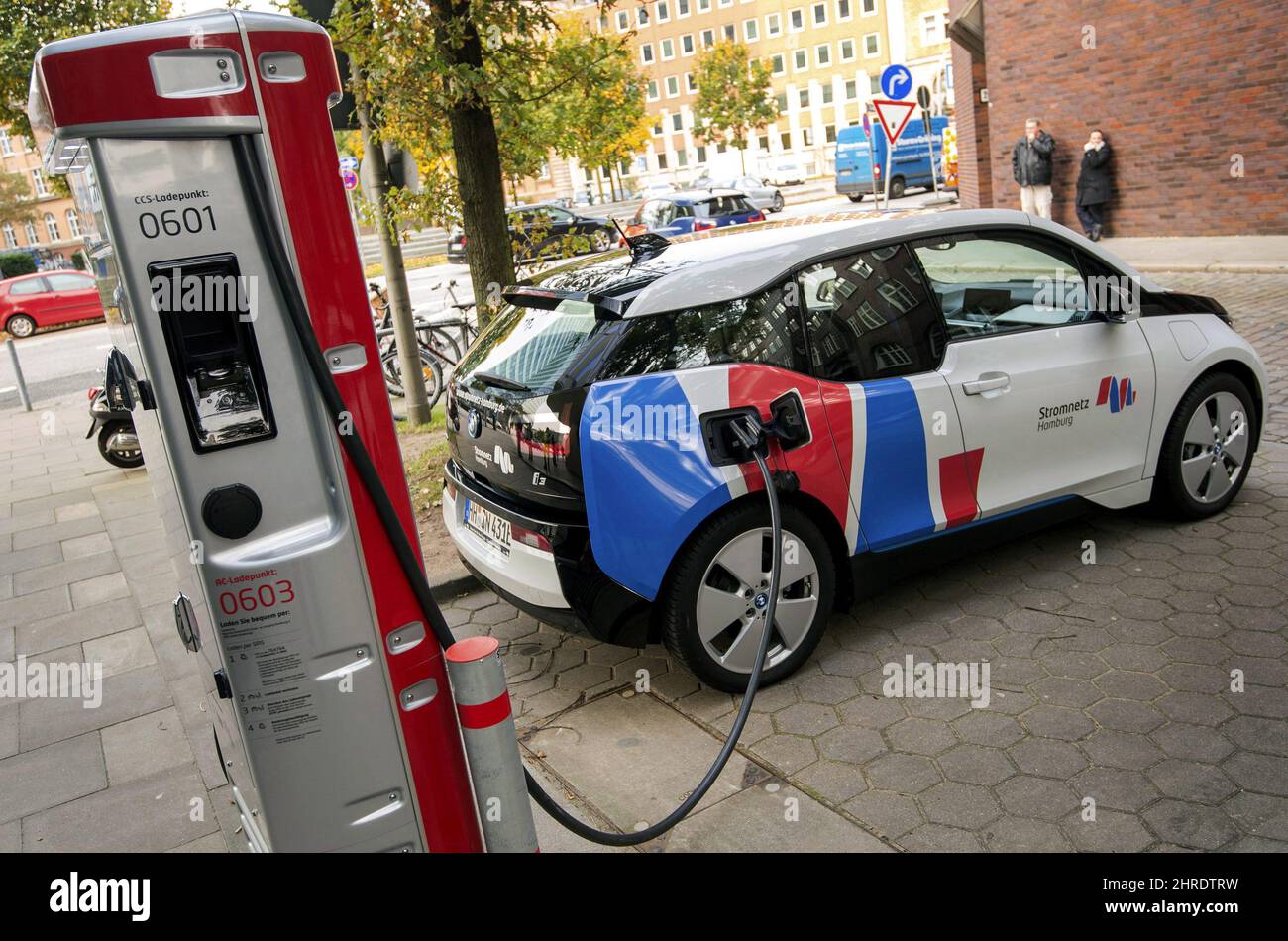 FILE - In this Wednesday, Oct. 18, 2017 photo a car is connected to a charging station for electric vehicles in Hamburg, Germany. A Canadian energy think tank says the world is less than a decade away from the tipping point at which electric cars will cost the same as conventional gas-powered vehicles. THE CANADIAN PRESS/Daniel Bockwoldt/dpa via AP, File) Stock Photo