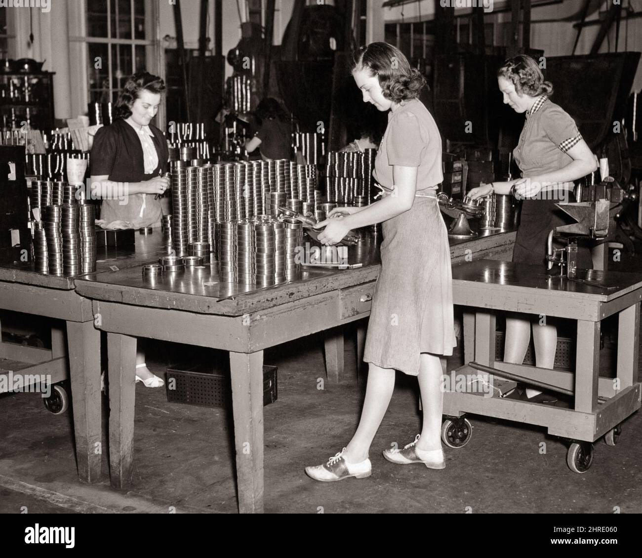 1940s WORLD WAR 2 WOMEN DEFENSE INDUSTRY WORKERS ASSEMBLING METAL,BALL BEARINGS AT ROLLER BEARING COMPANY - i3593 HAR001 HARS YOUNG ADULT PRODUCTION TEAMWORK SATISFACTION CONFLICT FEMALES WW2 JOBS COPY SPACE FULL-LENGTH HALF-LENGTH LADIES PERSONS TEENAGE GIRL B&W SKILL OCCUPATION SKILLS GLOBAL STRENGTH WORLD WARS ASSEMBLING SADDLE SHOES LABOR WORLD WAR WORLD WAR TWO WORLD WAR II OPPORTUNITY EMPLOYMENT OCCUPATIONS BEARING COMPANY STYLISH SUPPORT TEENAGED WORLD WAR 2 EMPLOYEE BEARINGS DEFENSE JUVENILES MID-ADULT MID-ADULT WOMAN YOUNG ADULT WOMAN BLACK AND WHITE CAUCASIAN ETHNICITY CIVILIAN Stock Photo