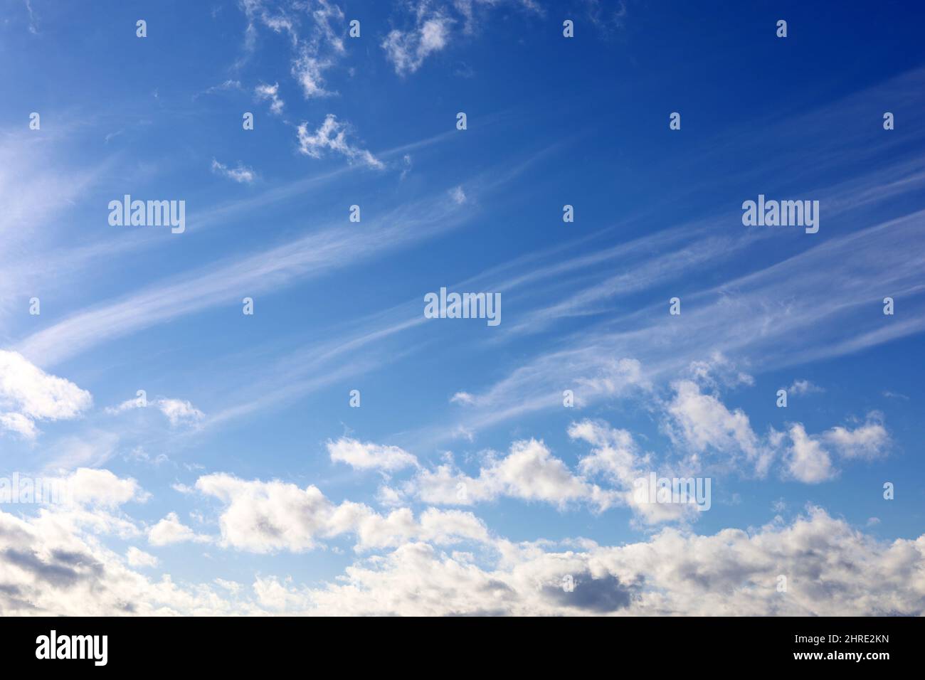 Blue sky covered with white cumulus and cirrus clouds. Spring ...