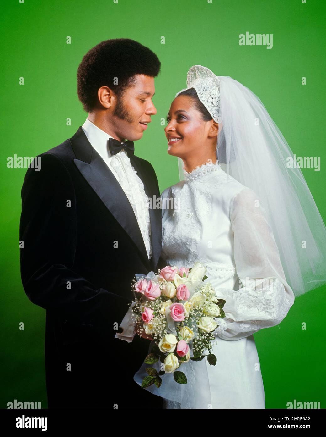 1970s PORTRAIT OF AFRICAN AMERICAN BRIDE AND GROOM LOOKING AT ONE ANOTHER MAN IN TUXEDO WOMAN WEARING GOWN VEIL HOLDING BOUQUET - kb8759 HAR001 HARS BOUQUET STYLE YOUNG ADULT TEAMWORK ROSE STRONG 1970s PORTRAIT OF AFRICAN AMERICAN BRIDE AND GROOM LOOKING AT ONE ANOTHER MAN IN TUXEDO WOMAN WEARING GOWN VEIL HOLDING BOUQUET - kb8759 HAR001 HARS BOUQUET STYLE YOUNG ADULT TEAMWORK ROSE STRONG