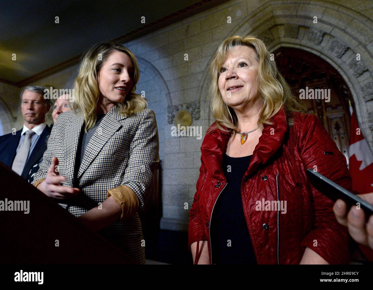 Minister of Canadian Heritage Melanie Joly recognizes Catherine Belanger, wife of late MP Mauril Belanger, who put forth the private member's bill to make the national anthem gender neutral, after Bill C-210 received royal assent, during a press conference in the Foyer of the House of Commons on Parliament Hill in Ottawa on Wednesday, Feb. 7, 2018. The line 'in all thy sons command' is now officially replaced with 'in all of us command.' THE CANADIAN PRESS/Justin Tang Stock Photo