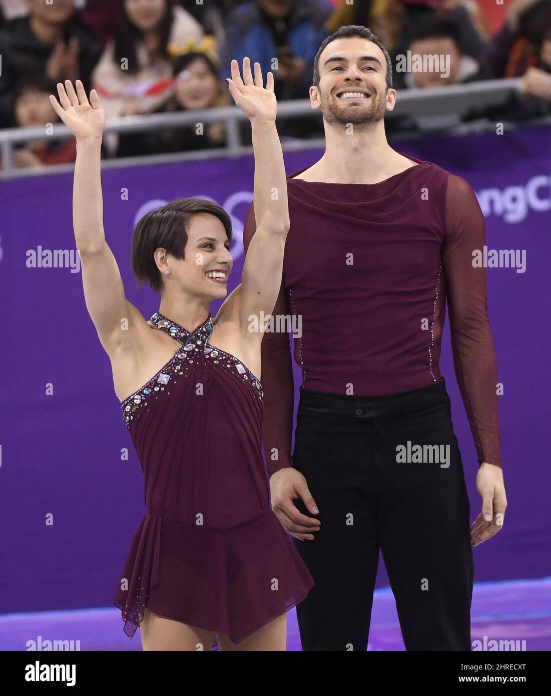 Canada's Meagan Duhamel and Eric Radford wave from the podium after