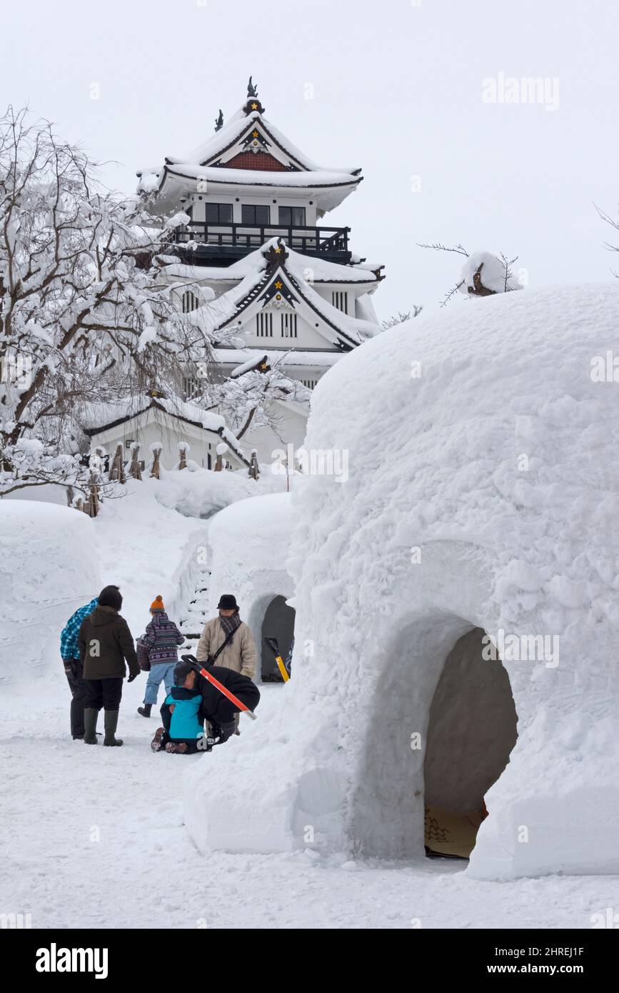 Tourists with Kamakura (igloo-like snow house) near Yokote Castle during Yokote Kamakura Festival,  Yokote, Akita Prefecture, Japan Stock Photo