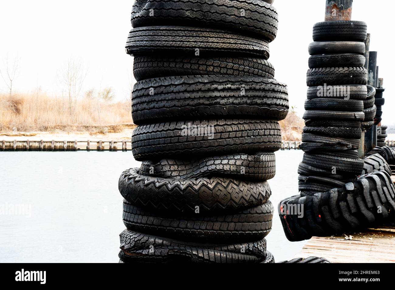Old tires as dock bumpers Stock Photo