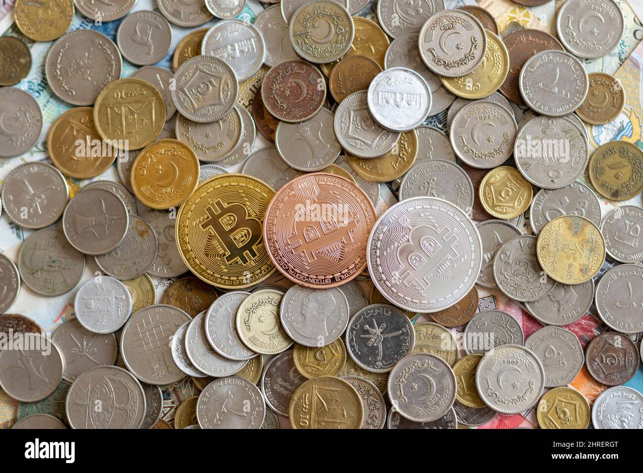 BTC over worldwide metal coins Stock Photo