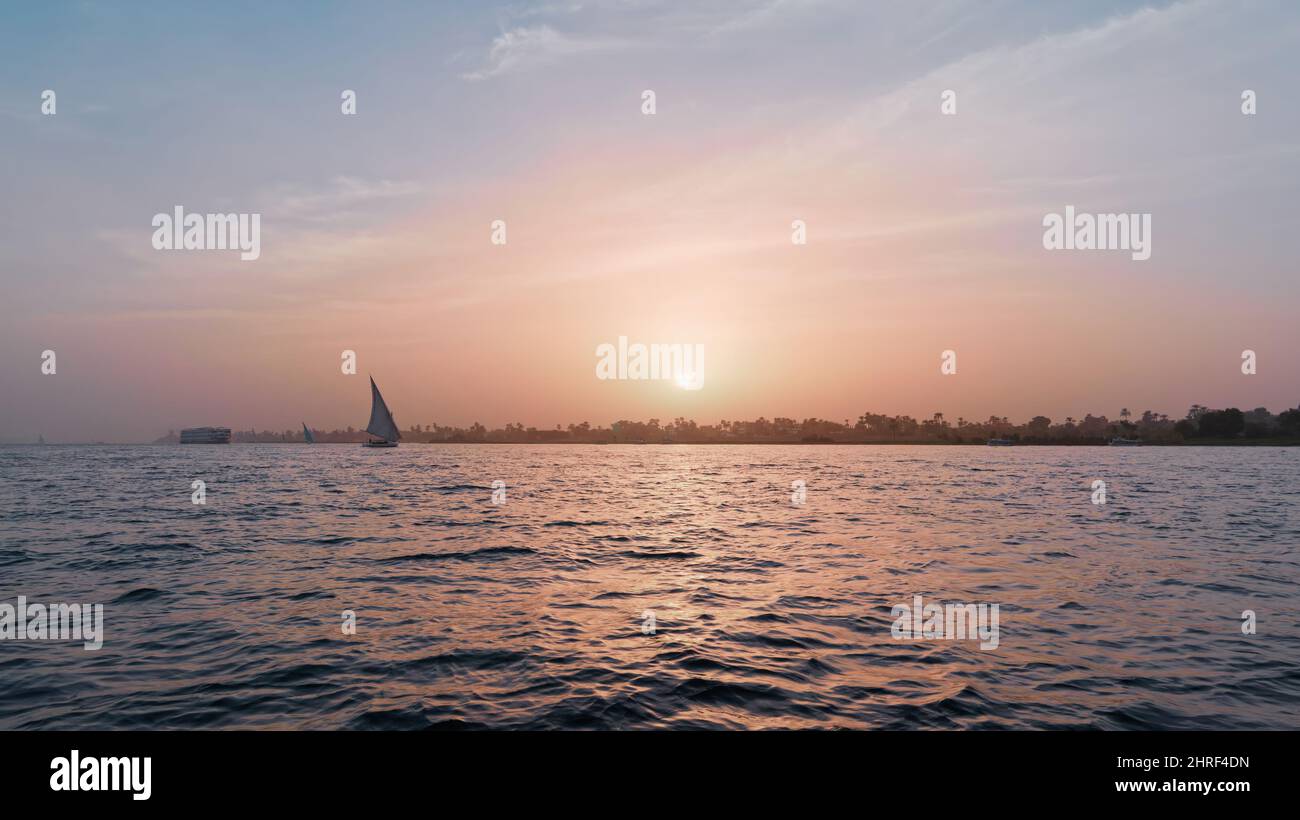Wide photo of a boat in the sea at sunset Stock Photo - Alamy
