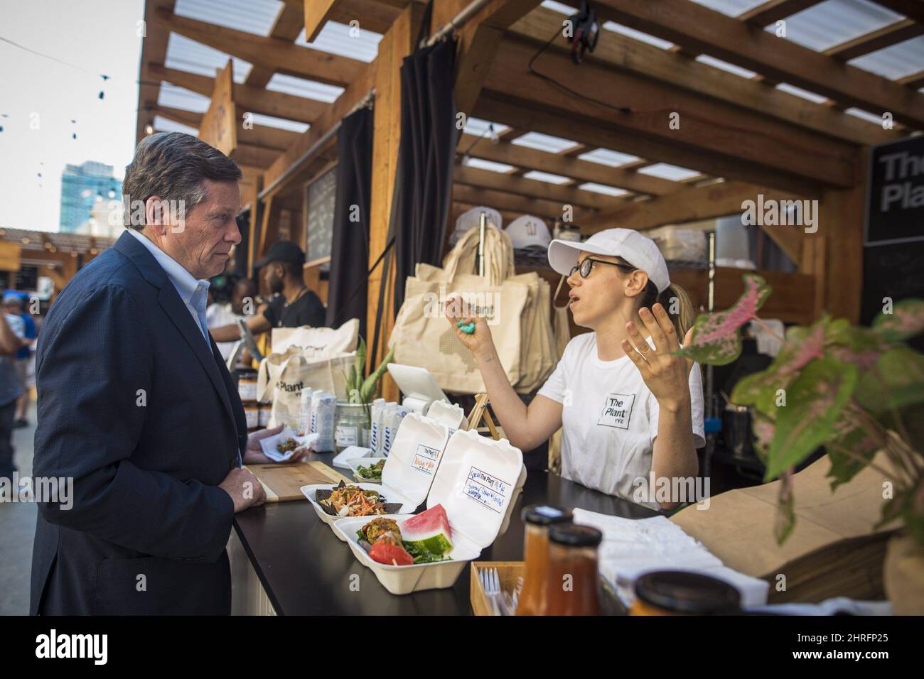 Toronto Mayor John Tory chats with Melanie Bozzo from The Plant YYZ during the official launch of Union Summer, an outdoor summer market outside Union Station, in Toronto on Tuesday, July 3, 2018. THE CANADIAN PRESS/ Tijana Martin Stock Photo