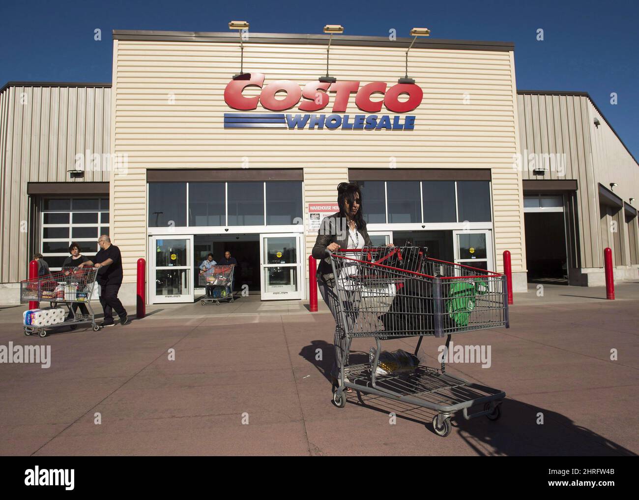 Customers push shopping carts at Costco in Mississauga, Ont., on Monday