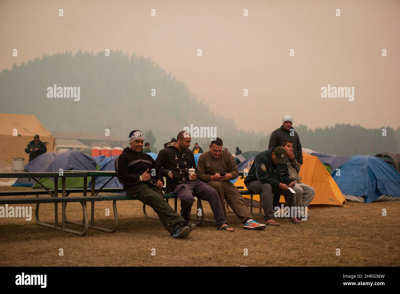 Firefighters from Mexico rest at a camp where wildfire firefighters and