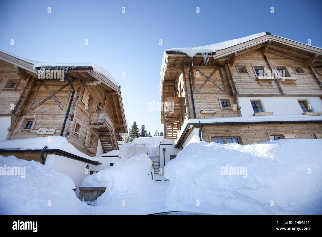 Low angle shot of wooden buildings covered in snow Stock Photo - Alamy