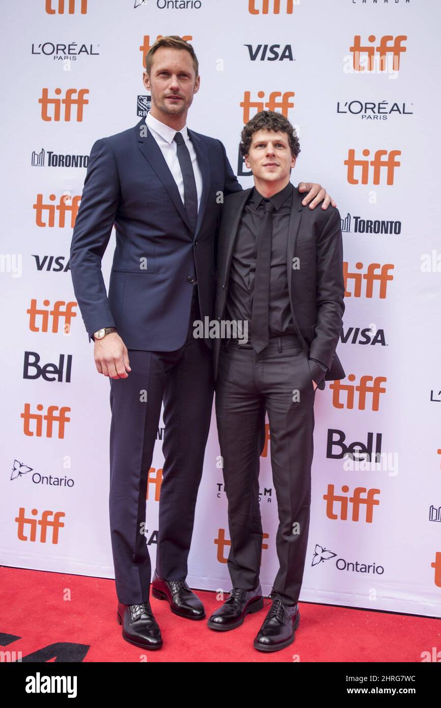 Actors Alexander Skarsgard, left, and Jesse Eisenberg poses for photos on the red carpet for the