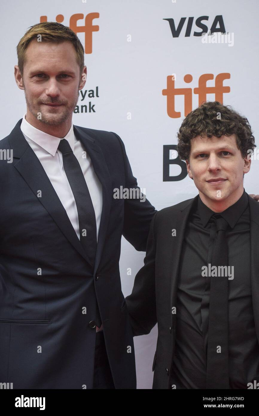 Actors Alexander Skarsgard, left, and Jesse Eisenberg poses for photos on the red carpet for the