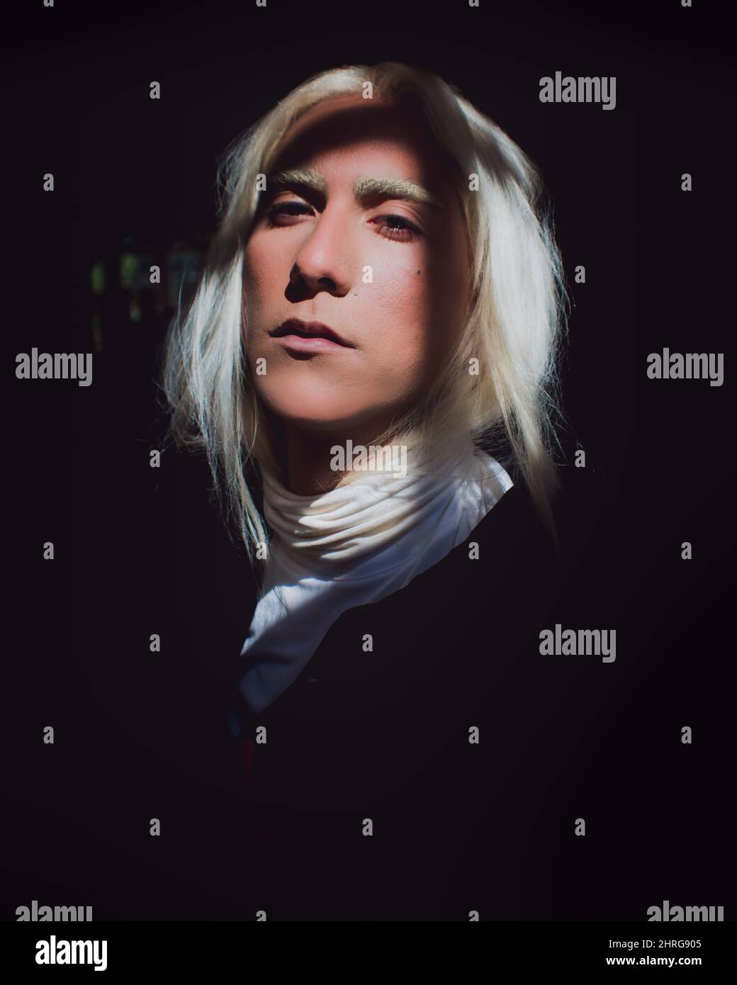 portrait-of-a-hispanic-male-with-white-hair-in-a-dark-room-with-the-sun