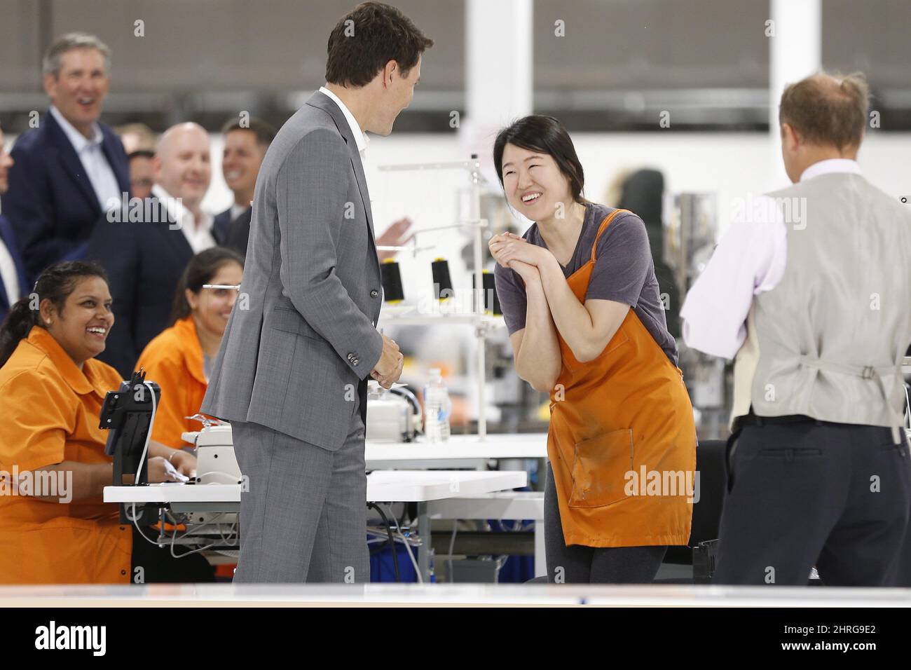 Canada Goose employee Seolhee Lee greets Prime Minister Justin Trudeau  during a brief tour of a new 700 employee Canada Goose manufacturing  facility in Winnipeg, Manitoba Tuesday, September 11, 2018. THE CANADIAN