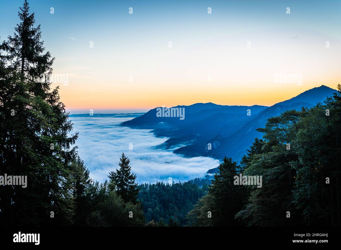 Scenic shot of the sea of clouds on top of a mountain during sunrise ...