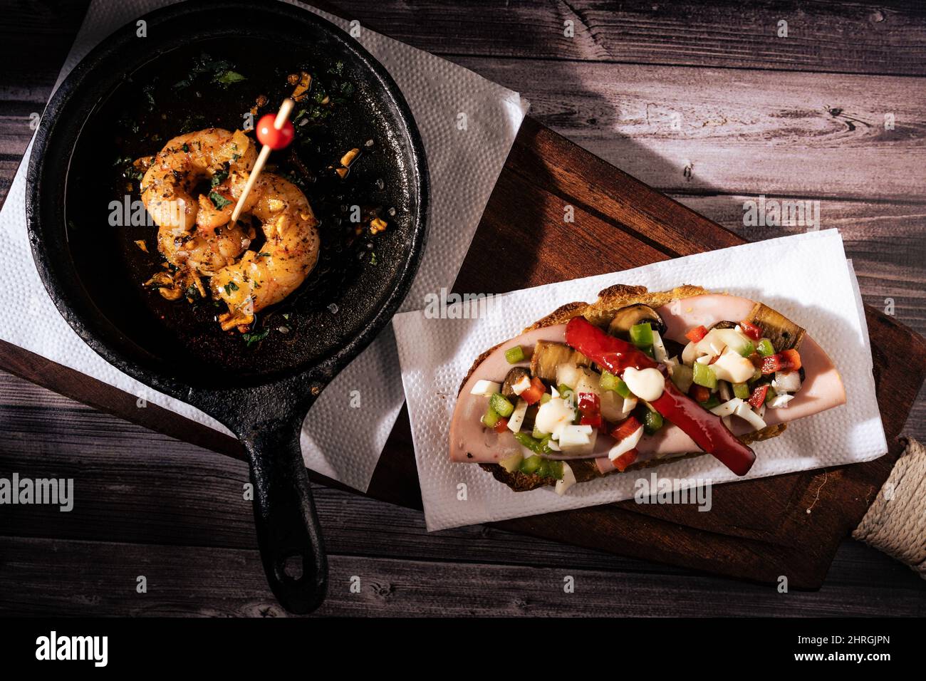 Two different typical Spanish tapas on a rustic table with a dark
