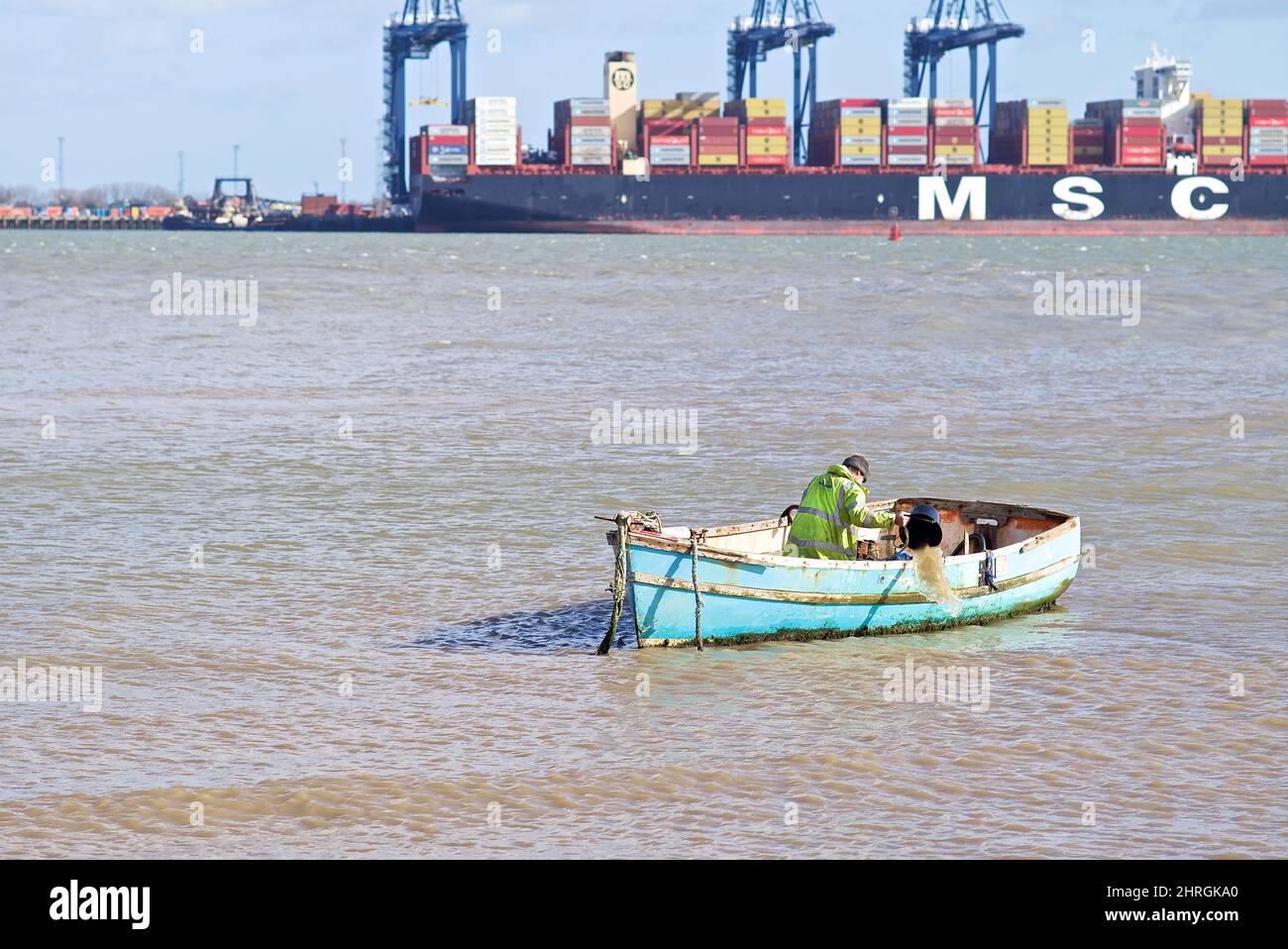 Fisherman bailing out his boat before going out to fish. Stock Photo