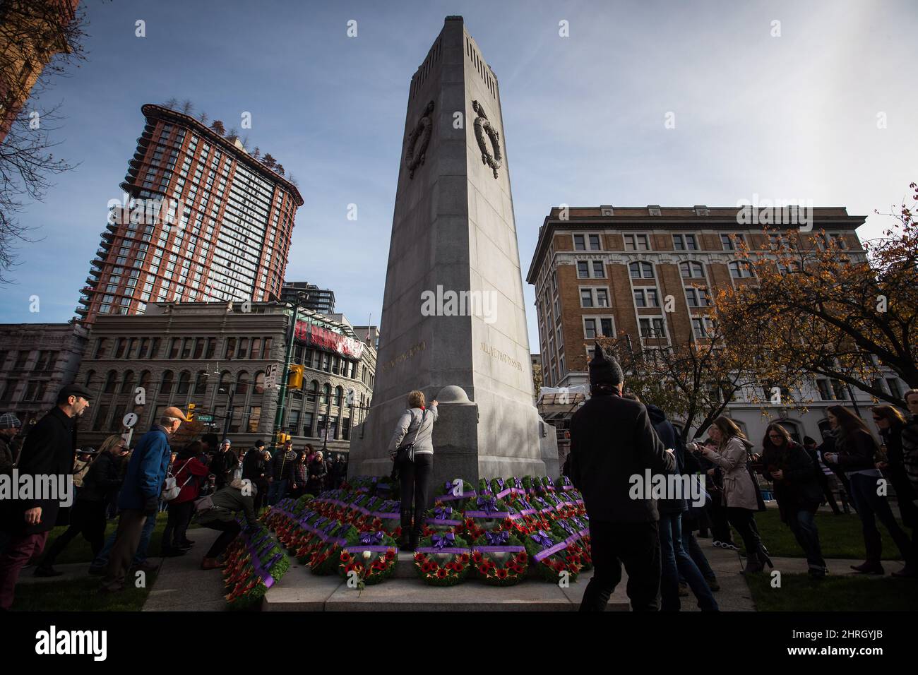 People place their poppies on the Victory Square Cenotaph after a ...