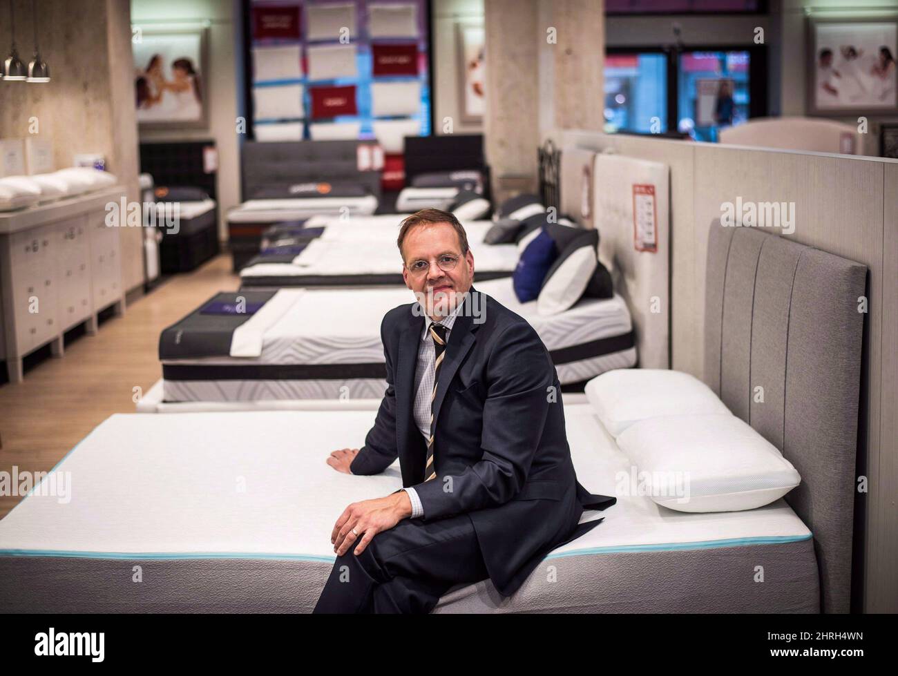 David Friesema the CEO of Sleep Country Canada sits on the new Bloom mattress as he poses for a photo at a store in Toronto on Wednesday May 10 2017. Sleep Country