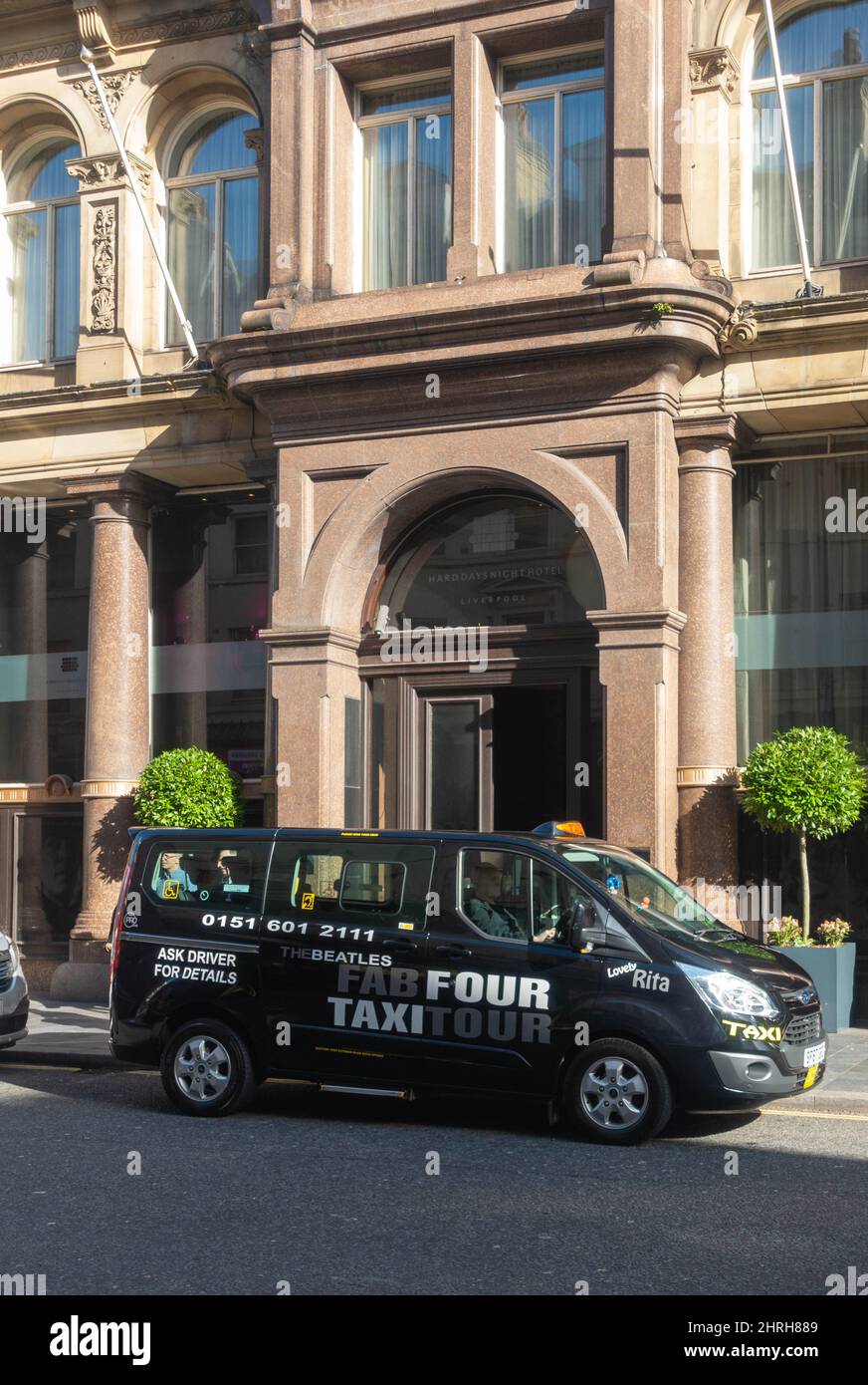 Fab Four Taxi Tour van in front of the Hard Day's Night Hotel in Liverpool Stock Photo