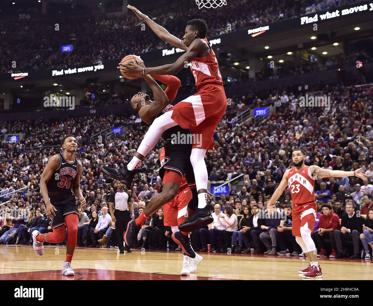 Toronto Raptors forward Chris Boucher (25) fouls Chicago Bulls guard Kris  Dunn (32) driving to the