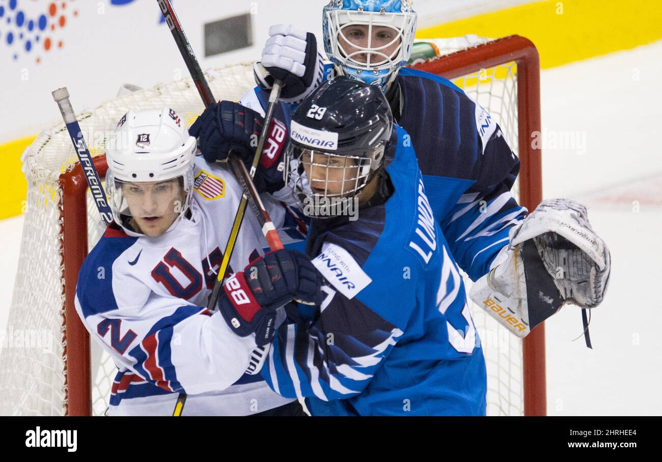 Finland's Anton Lundell (29) tries to clear United States' Logan Cockeril, left, from in front of Finland goalie Ukko-Pekka Luukkonen during first period IIHF world junior hockey final action in Vancouver, Saturday, Jan. 5, 2019. THE CANADIAN PRESS/Jonathan Hayward Stock Photo