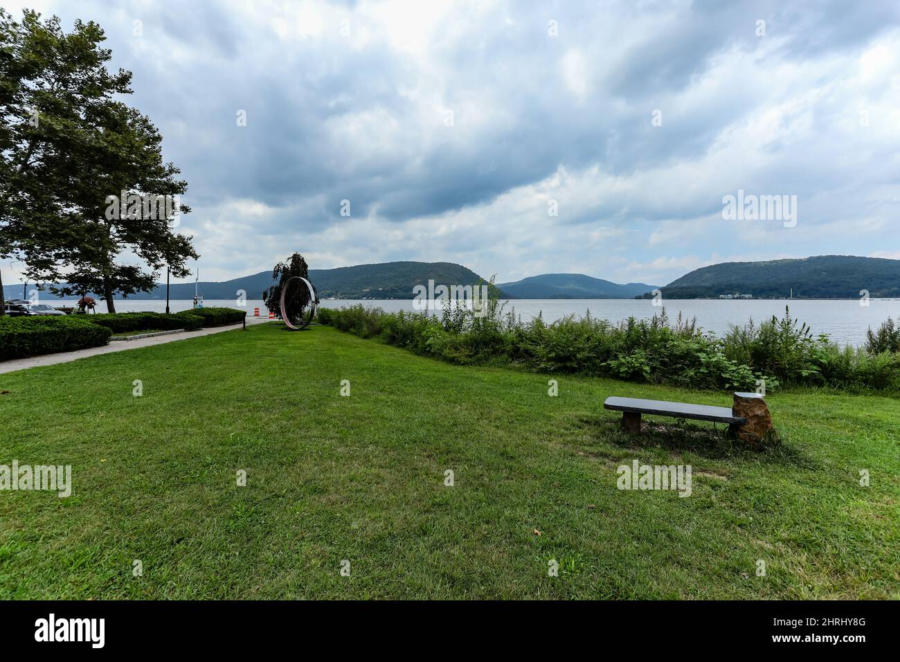 Beautiful waterfront landscape field with an empty bench in Peekskill