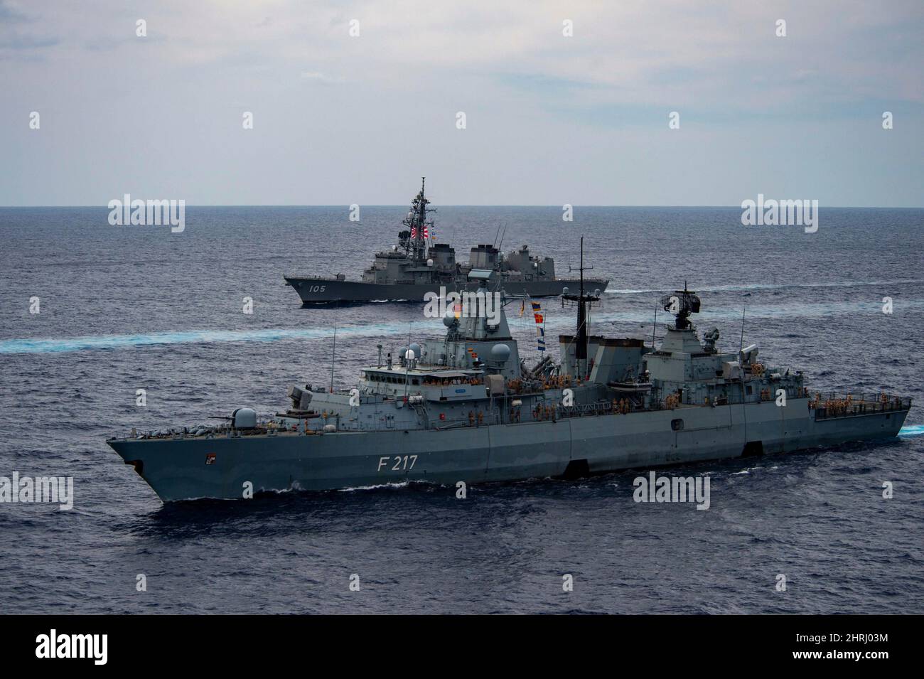 The German Navy Brandenburg-class frigate FGS Bayern, Japan Maritime Self-Defense Force Murasame-class destroyer JS Inazuma, sail in formation during exercise ANNUALEX 21 November 21, 2021 in the Philippine Sea. Stock Photo