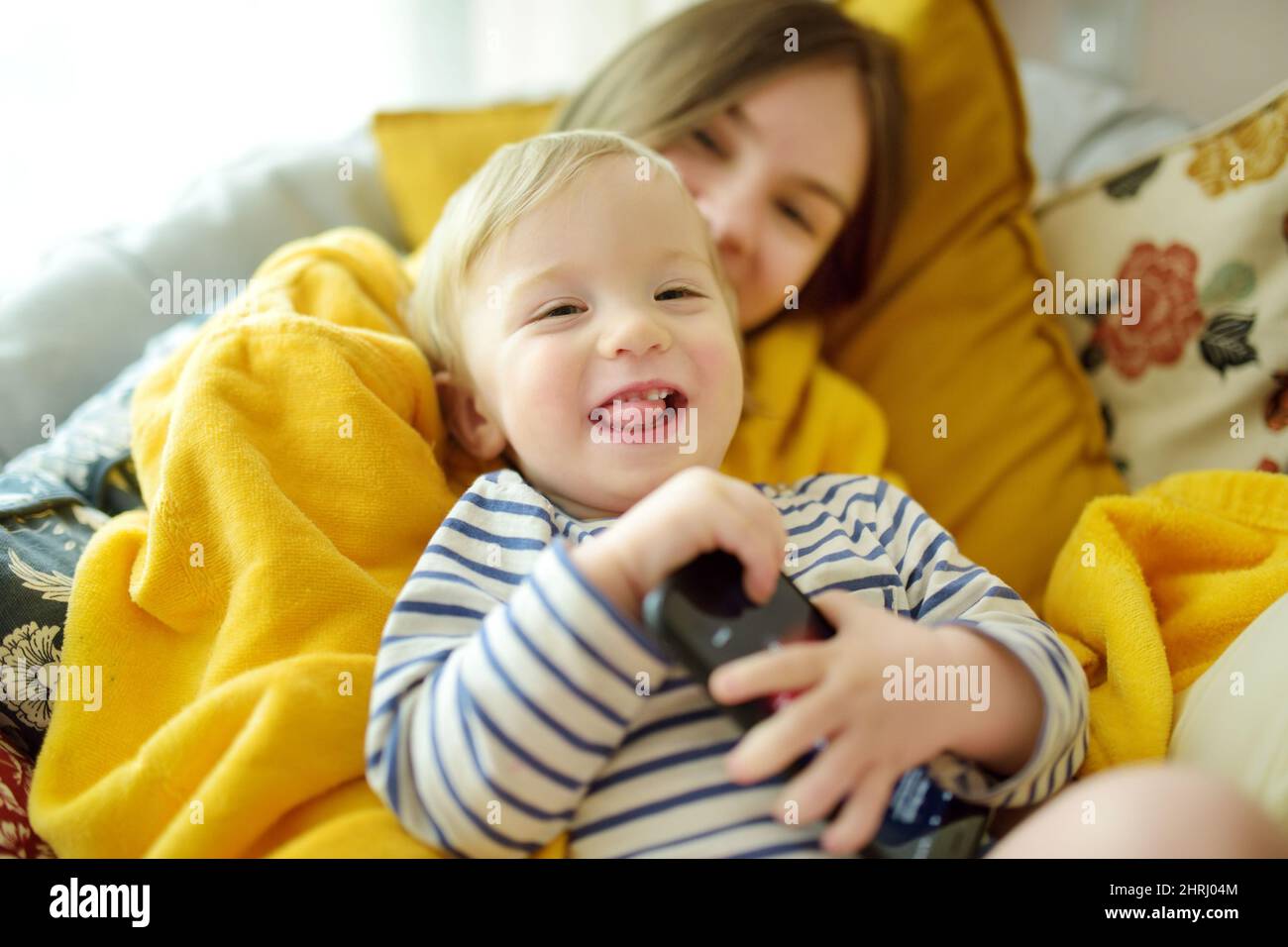 Cute big sister cuddling with her toddler brother. Adorable teenage