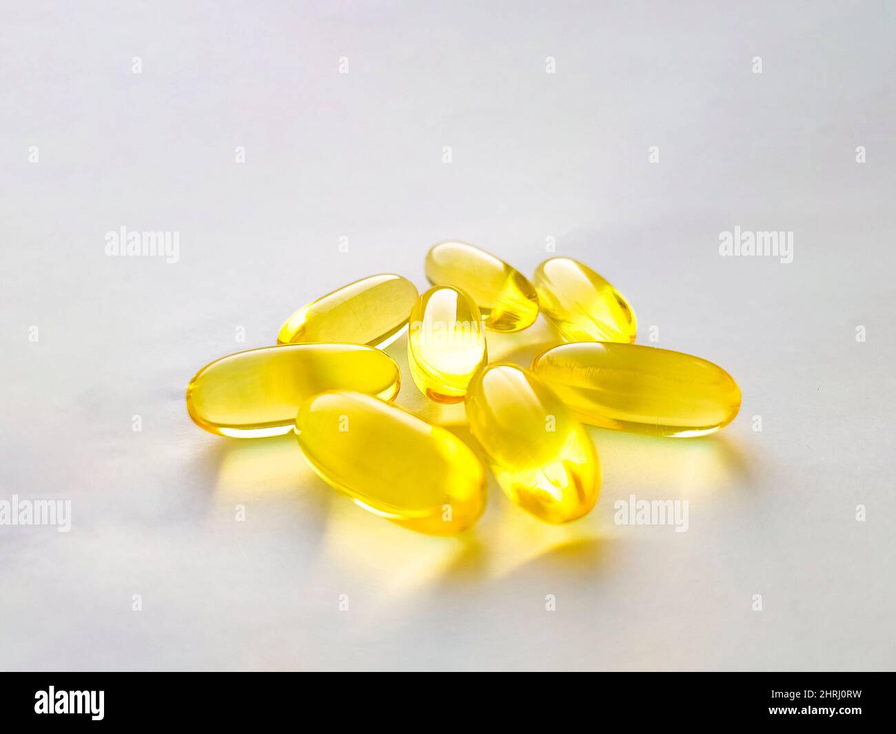 Closed capsules with dietary supplement: fish oil, omega 3, vitamin A, vitamin D, vitamin D3, vitamin E. Selective focus. Stock Photo