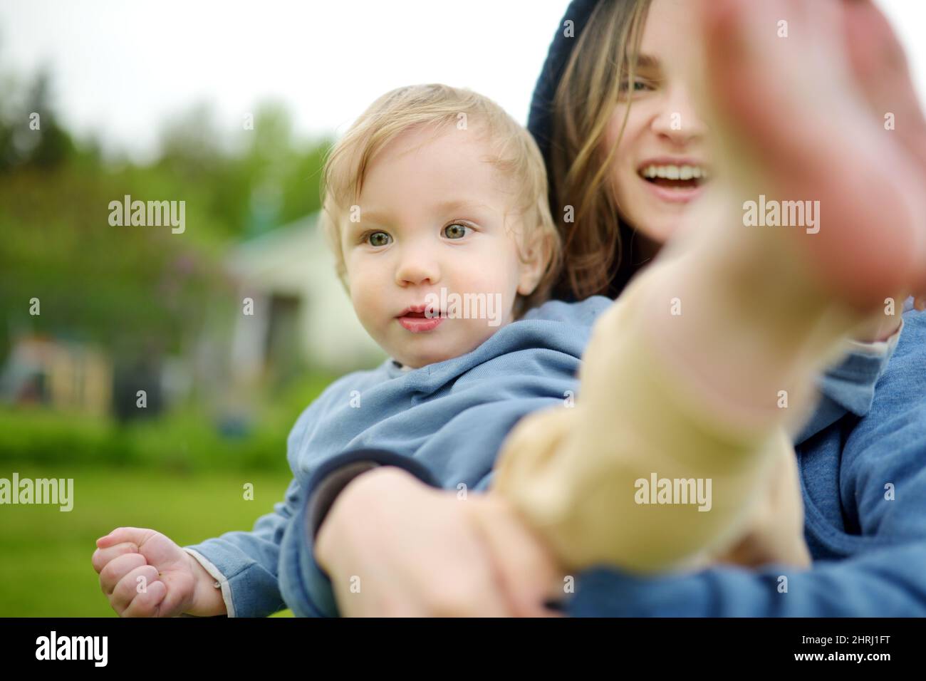 Cute big sister cuddling with her toddler brother. Adorable teenage