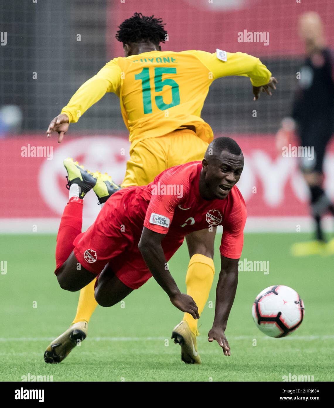 Canada's Zachary Brault-Guillard, front, is tripped by French Guiana's Miguel Haabo during the second half of a CONCACAF Nations League qualifying soccer match in Vancouver, on Sunday March 24, 2019. THE CANADIAN PRESS/Darryl Dyck Stock Photo