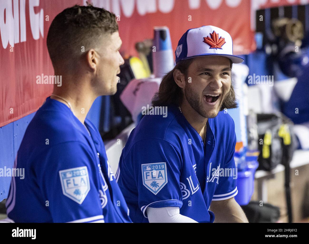 Toronto Blue Jays' Bo Bichette, right, shares a laugh with