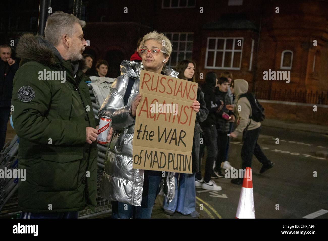 London, UK, 25th Feb 2022 A woman holding a protest sign outside the Russian Embassy following Russia's recent attack on the Ukraine. Credit: Kiki Streitberger/Alamy Live News Credit: Kiki Streitberger/Alamy Live News Stock Photo